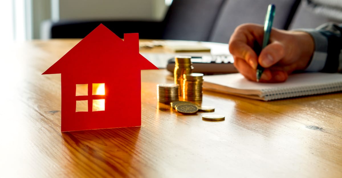 man counting money next house