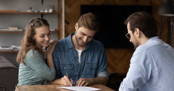 happy people signing house contract