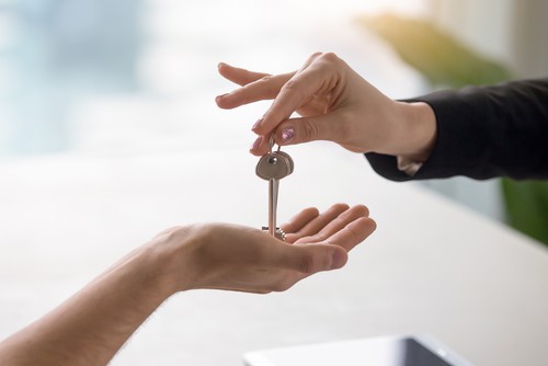 Conveya cing solicitor handing over keys to buyer